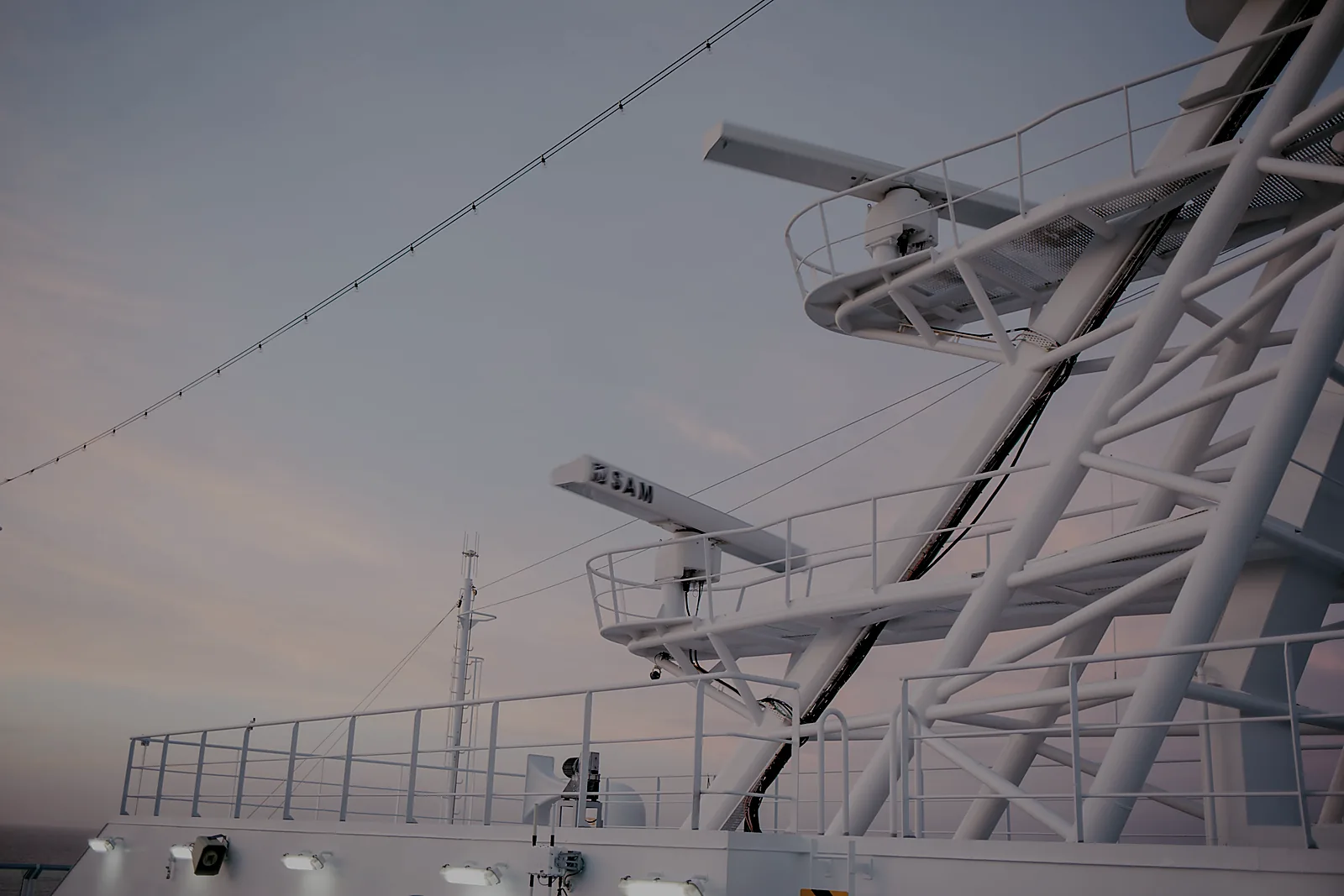 Ship radar and communications equipment at dusk